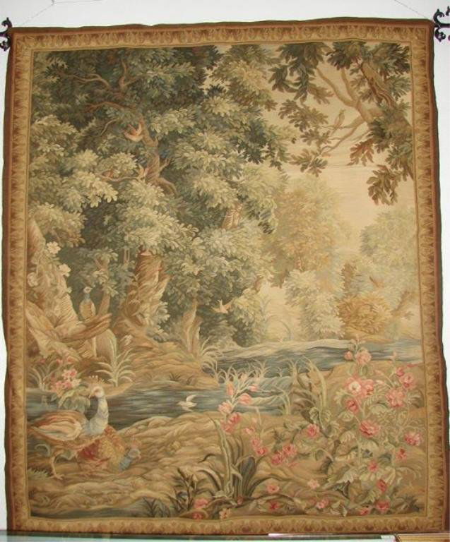 Hand Woven Tapestry, 20th C.: Labeled, Hand Made for "Ethan Allen", with the wrought iron supporting rod. Depiction of birds in a wooded landscape setting. H - 76", W - 64". compete with wrought iron support.