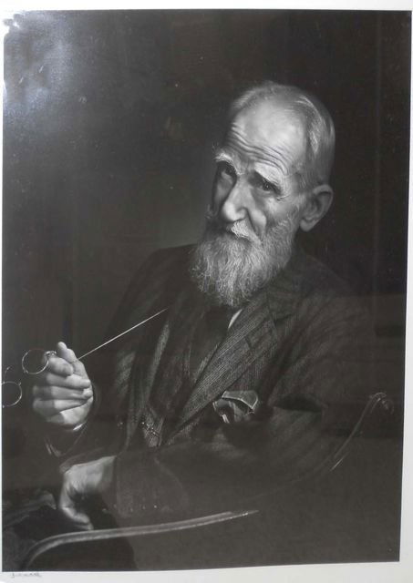Yousuf Karsh, George Bernard Shaw.: H - 19 3/4", W - 15 3/4". Black-and-white portrait, the author three-quarters view turned to the camera and holding lorgnettes. Signed under the image. Glazed, mounted and framed.