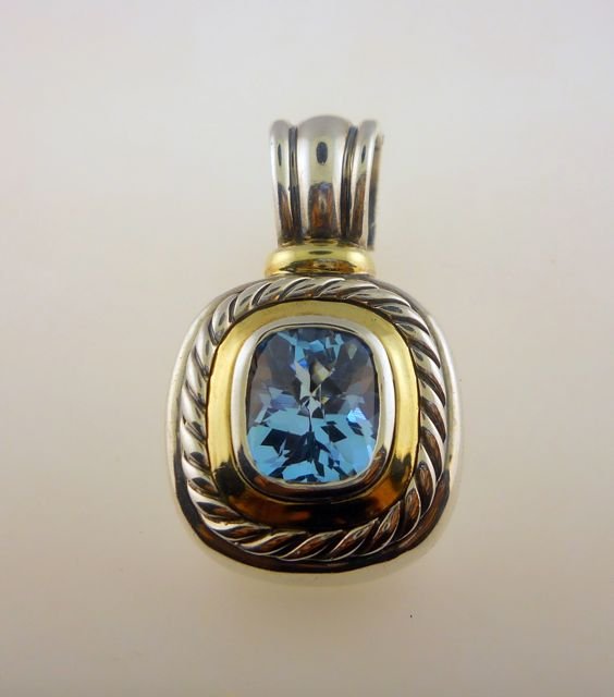 David Yurman S/Silver 14K YGold Topaz Enhancer.: David Yurman Sterling Silver and 14K Yellow Gold Enhancer. The stone is a cushion cut blue topaz. Classic rope detail. The enhancer weighs 19.9 grams. [AWP359]"