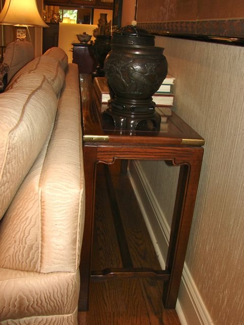 Chinese Style Carved Oak Sofa Table.: H - 28", W - 54", D - 15". Rectangular top with brass corners supported on four square legs joined by an "H" form stretcher base.