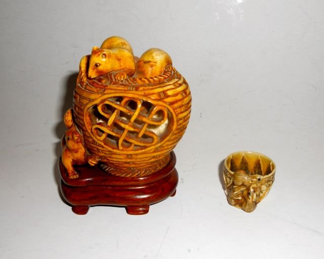 Two Carved Ivory Miniatures: Squirrels in a basket H - 3" and three mice in a tea cup, H - 1".. Both pieces are signed.