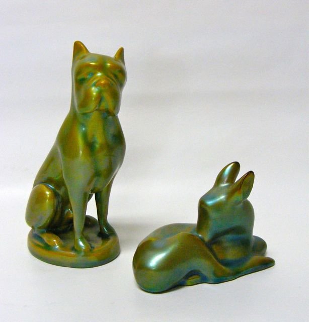 Two (2) Zsolnay Porcelain Figurines. Dog and Doe.: Both with the Zsolnay hallmark on the bottom, finished in iridescent green luster glaze. Dog - Height - 5 inches, Doe Height - 2.25 inches.