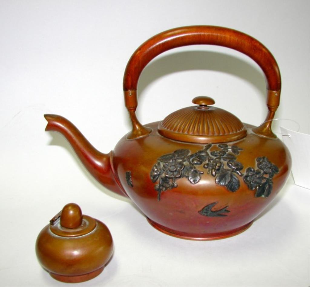 Rare Gorham Copper Japonisme Tea Pot.: Height 7 ins. The body of the pot is adorned with sterling cherry blossom branches and swallows in flight. The lid is ribbed. The hardwood handle is orignal to the pieces. Condition: minor dents. Incl