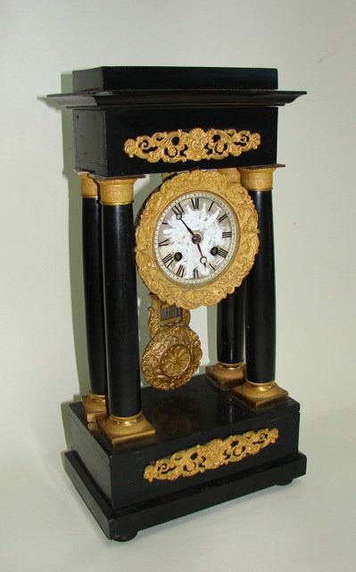 French Louis XVI Style Portico Mantle Clock.: Ebonized wood case with dore bronze mounts. Condition: Repainted dial.