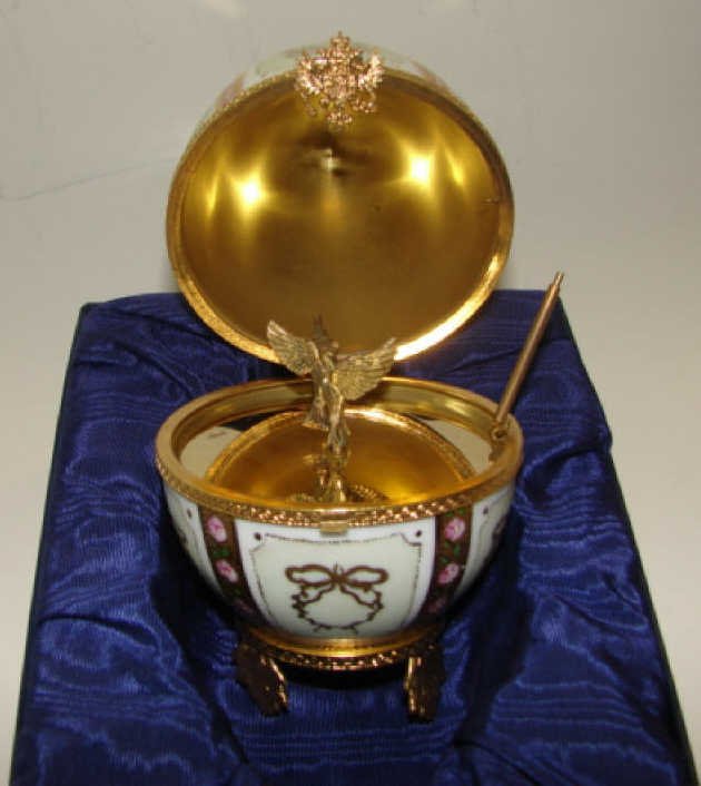 Faberge / Limoge Porcelain Egg Music Box. Doves.: Beautiful hand painted Porcelain music box with gilt washed silver interior of dancing doves, bearing the edition # 367, with with silver hallmarks. Condition: Not in working order.