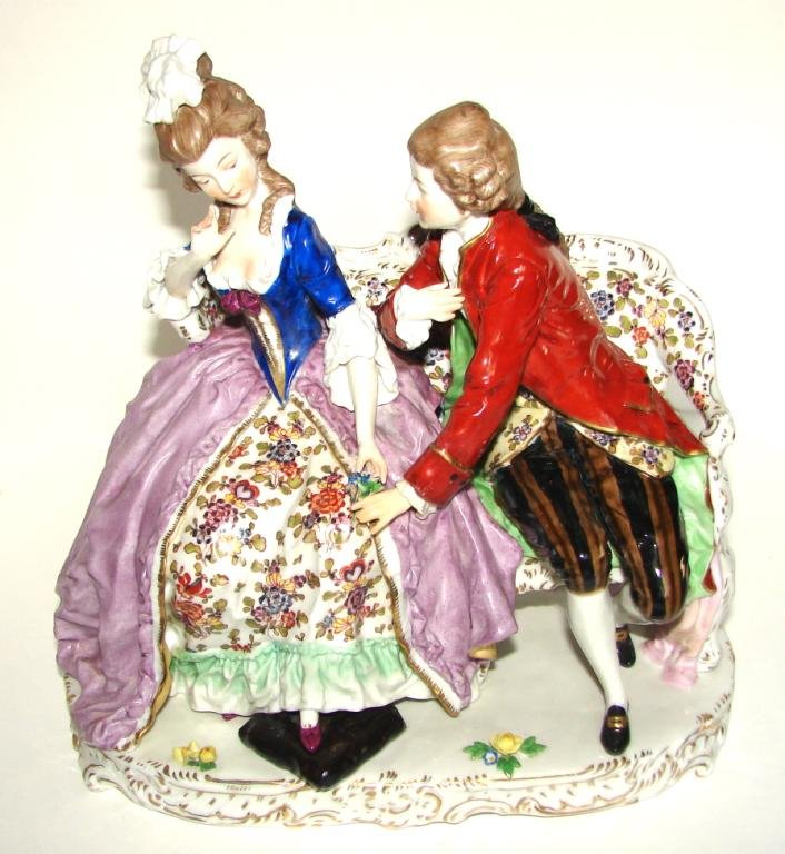 Porcelain Capo di Monte. Courting Couple.: Porcelain figural group. Capo di Monte. Courting scene with 18th century lady and gentleman. Height - 10 1/4 inches. Depicting a lady and gentleman in 18th century dress seated on a settee in a pose o