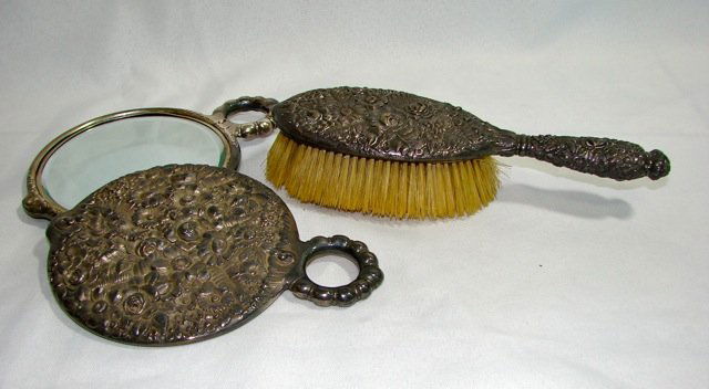 3 Piece Tiffany & Co. Sterling Dresser set.: Comprising a hair brush and pair of hand mirrors, all with floral repousse decor. The handle of the brush has the Tiffany & Co. hallmark.