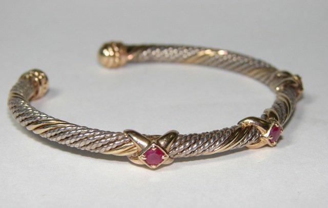 Sterling Silver & 14K Yellow Gold Bangle..: Sterling Silver & 14K yellow gold cuff. Woven pattern with three X shapes across the top with a ruby set on top of each. Gold and Silver twisted. Gross weight 15.8 grams.