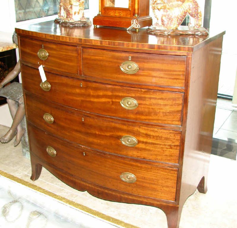 Mahogany Bow Front Chest of Drawers. 19th C.: In the Hepplewhite manner with two drawers over three graduated drawers, French foot. 42 x 44 x 25 inches. Condition: some loss of veneer to feet.