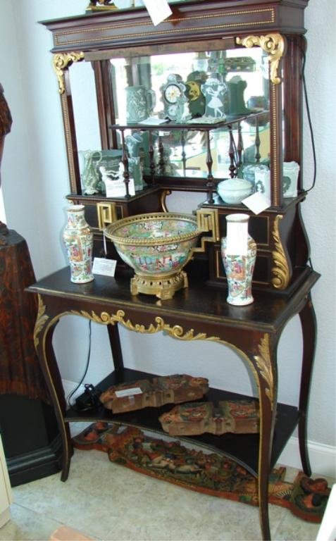 French Style What-Not Console Cabinet: the upper case with bronze mounted cornice above shelves with turned post supported and beveled mirror back, supported on a bases with gilt carved acanthus decor. Electrified. 68 x 34 x 18 inches.