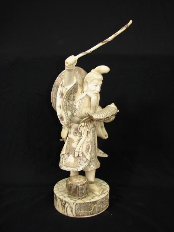 Japanese Carved Bone Figurine.: Height - 16 inches, 18 inches with spear. Signed on the bottom.