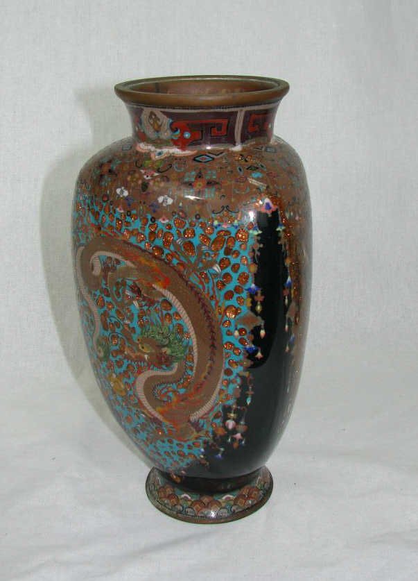 Fine Japanese Cloisonne Vase: Ovoid form, meandering dragon decor reserves, so apparent marks or signatures. Height - 10 inches. Condition: slight corrosion of the metal on the base rim but no loss of enamel noted.