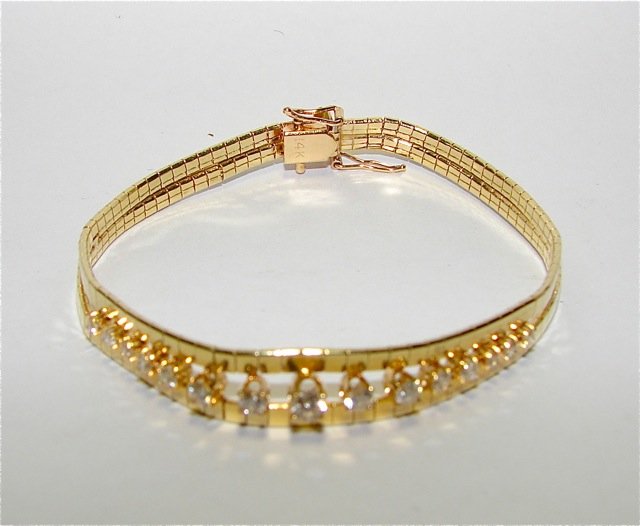 14K Yellow Gold & Diamond Lady's Bracelet: Lady's yellow gold 7 inch split center mesh bracelet with snap clasp. Stamped 14K weighting 13.5 grams. Set in four prong are 15 round brilliant cut diamonds ranging in size from 0.035 - 0.15 carat wi