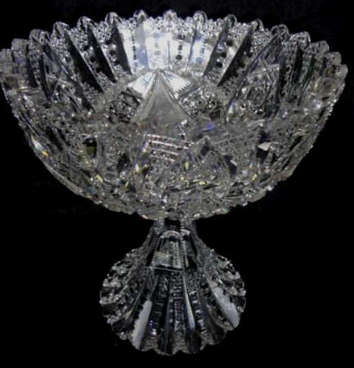 American Brilliant Cut Glass Compote by Libbey: Libbey maker. Height - 7 5/8 inches, diameter 7 1/4 inches. Glenda pattern, signed "Libbey" with the saber. The compote has a skirt foot fully cut with pattern. Condition: Small chip under foot rim.