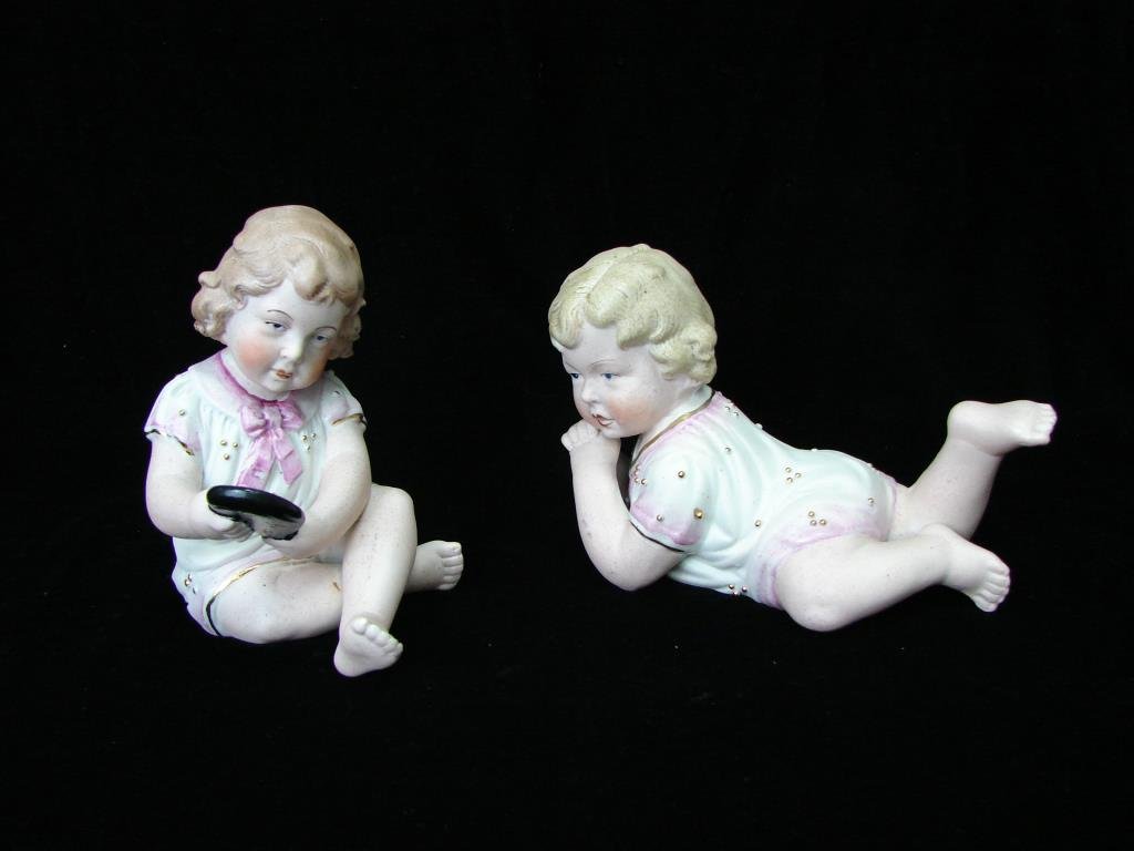 Two German Bisque Piano Babies: Height 5 and 4 inches. Impressed "Germany" on the bottom.