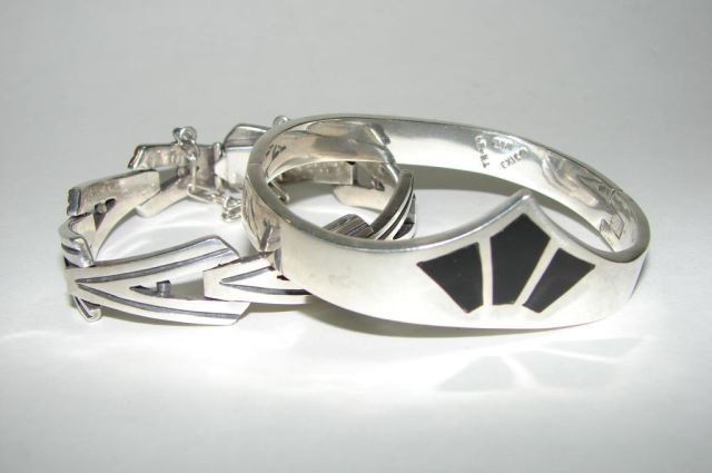Two (2) Vintage Sterling Silver Bracelets: 3.08 troy ounces total weight. Comprising a chevron link bracelets hallmarked "Sterling, 925" and a Mexican sterling hinged bangle bracelet with black enamel inlay.