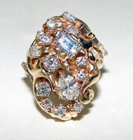 14K Yellow Gold Diamond "Brutalist" Cluster Ring: 15.8 grams total weight. The Cluster ring has prong set diamonds, including one emerald cut, approximately 1/2 carat, one oval cut, approximately 1/2 carat, 6 baguette cut, .15 carat ttal weight, and