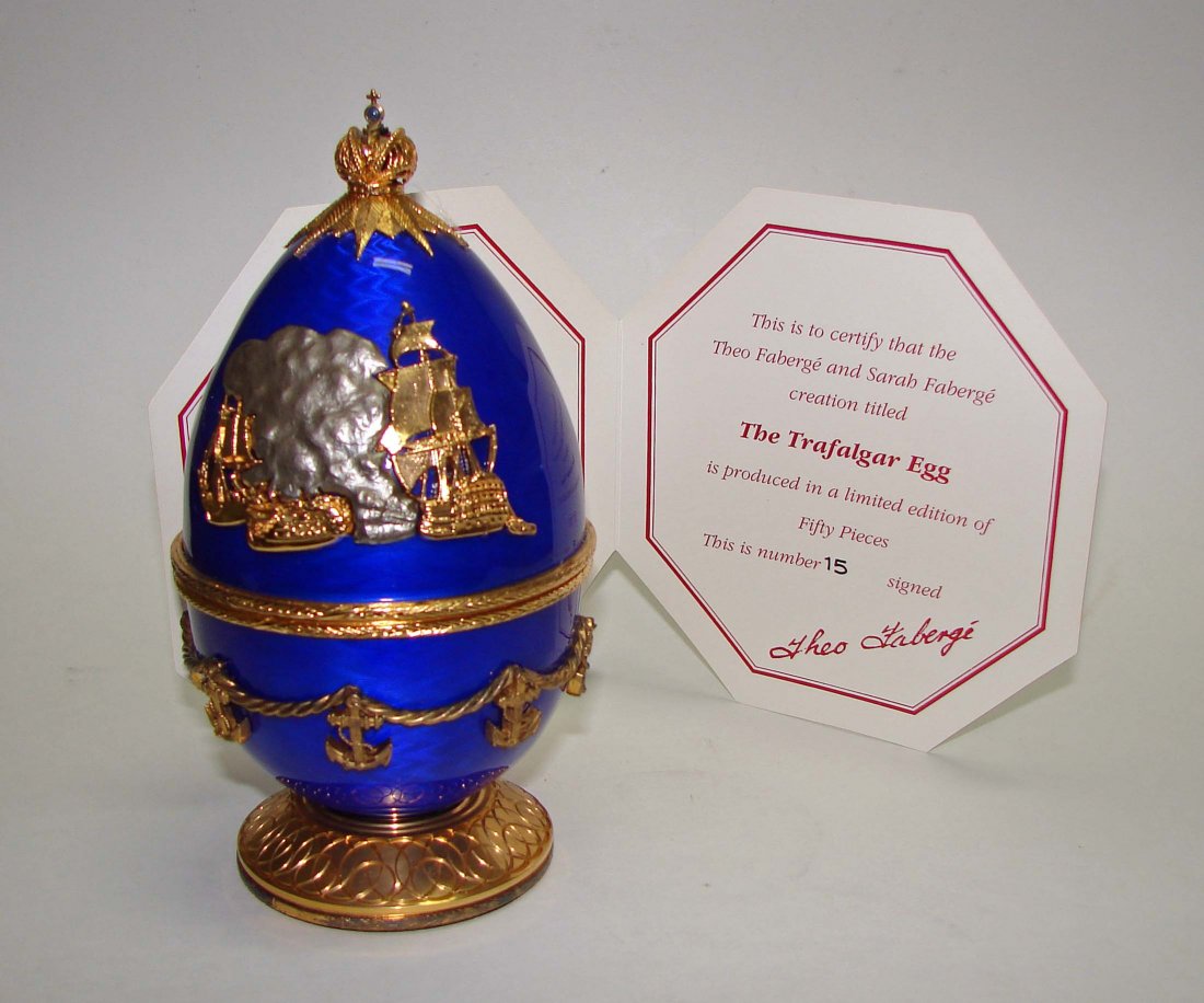 Faberge - The Trafalgar Egg: The rich cobalt blue egg, is adorned with motifs from Auguste Mayer's painting 'Redoubtable at Trafalgar' featuring the vessel from which Lord Nelson received his fatal shot. With COA but No box.
