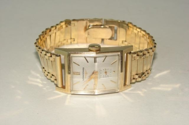 Longines 14K Yellow Gold Gent Watch: 14K yellow gold case, 14K yellow gold custom band. Mechanical movement, running condition. Size 7, 51 grams.