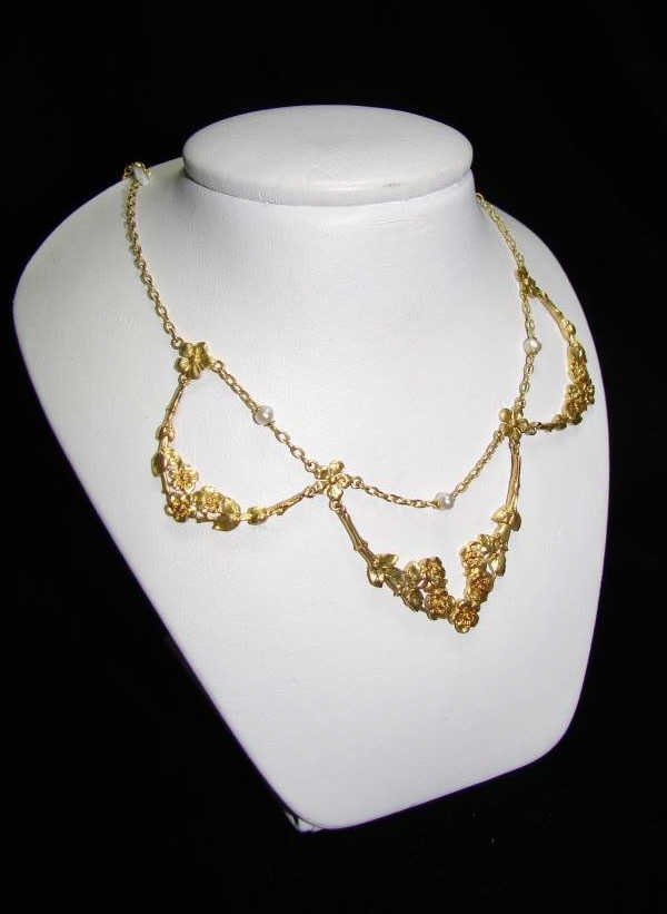 21K Yellow Gold/Seed Pearl Victorian Choker: The necklace is not marked but tested for 21 karats. Comprising three garland suspended from a chain with central seed pearls. Length - 15.5 inches. 10 grams in weight.