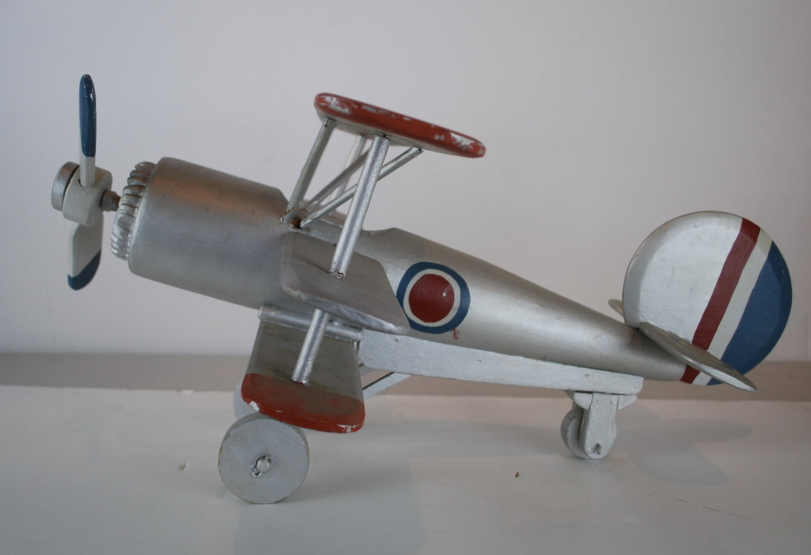 British Sopwith Triplane: 1917 British Sopwith Triplane Folk Art home made c.1950/60s Silver painted wood with wooden propeller and wheels also movable , Some repairs to spokes otherwise in good to fair condition, minor scratc