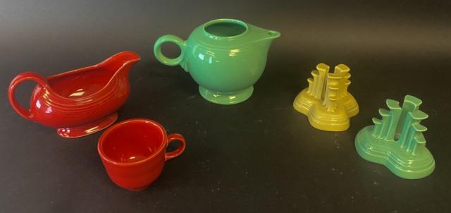 5 Pieces Vintage Fiestaware: 2 Pyramid or Tripod candlesticks, 1 Sea Foam and 1 Yellow; Sea Foam tea pot (no lid); Red gravy boat and cup. All vintage and marked with lowercase f Fiesta.