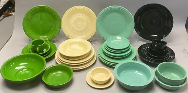 38 Pieces Fiestaware Including Vintage: 7 Black, 7 Shamrock including vintage serving bowl and soup bowl marked with lowercase f, 14 Sea Mist Green including 9 vintage pieces, 10 vintage Ivory. Plates 10 1/2"-diameter