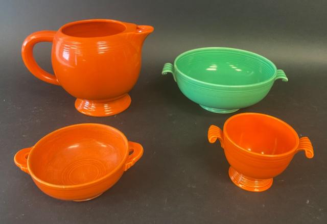 4 Pieces Fiestaware Including Vintage: Tangerine teapot (missing lid), Tangerine sugar bowl (missing lid), Tangerine handled dish, Sea Foam Green footed casserole with scroll handles (missing lid). Teapot, small dish and casserole all vint