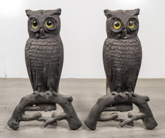 Pair of Owl Andirons: Pair of cast iron owl andirons with inset glass eyes. Eyes glow when lit from behind. Each 15"H x 16"L