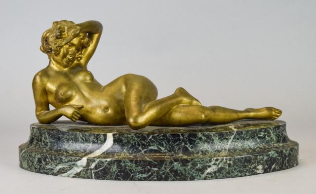 Bronze Nude on Marble Base: Bronze of a reclining nude, mounted on marble base. Bronze 12"L x 5"H, with base 13 1/4"L x 7". Chips to marble