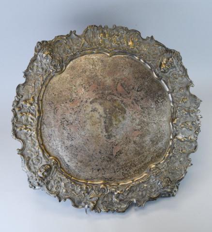 English Silverplated Allegorical Scene Salver: Large footed silverplated tray, with repousse mythological scene rim and etched or hand chased center with birds & flowers. Impressed crossed keys mark on underside, possibly J. Green & Co., Sheffield