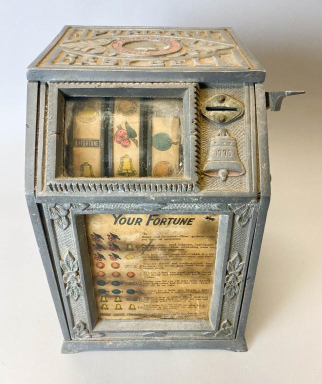 1Â¢ Lion Mfg. Co. Puritan Baby Bell Slot Machine: 1Â¢ Lion Mfg. Co. Puritan Baby Bell Slot Machine. Machine is marked with 1776-1928 on both left and right sides. Machine still operates with a penny, and the reels and mechanics are in good working 