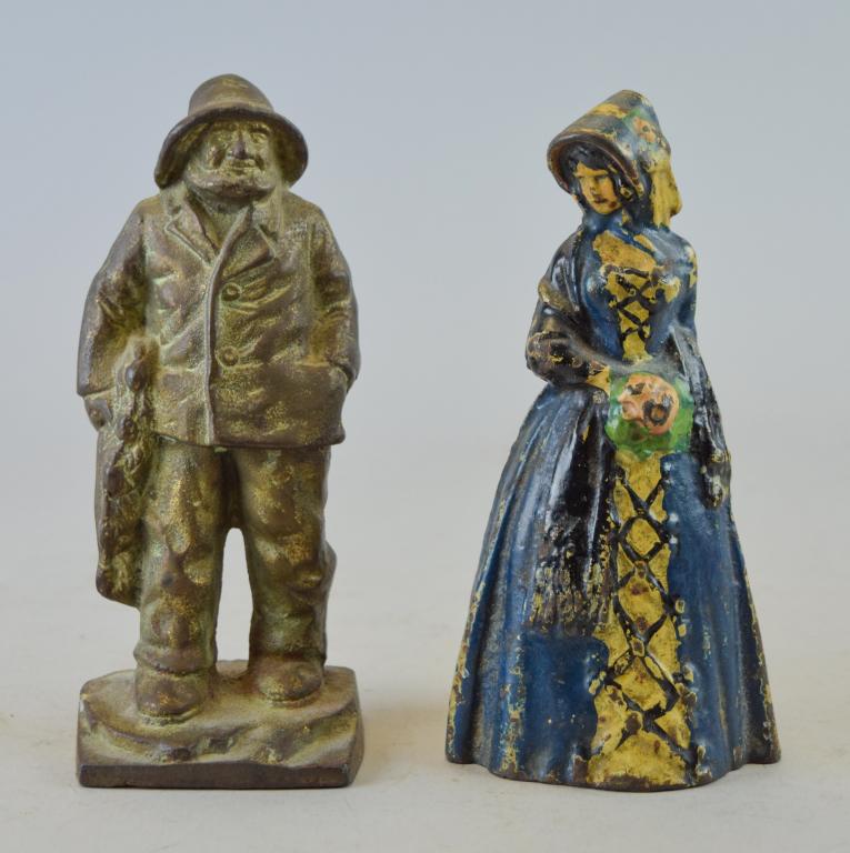 Fisherman and Lady Doorstops: Lot includes cast iron fisherman doorstop, 7"T; cast iron Victorian lady doorstop, 6 1/2"T. Wear and paint loss consistent with age