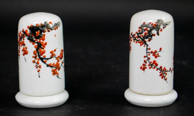 Pair of Miniature Japanese Erotic Porcelain Pieces: 2 Miniature Japanese erotic porcelain containers. Embellished with erotic scenes on the inside and cherry blossom on the outside. 3 1/4" H x 1 3/4" D. Line in base of 1