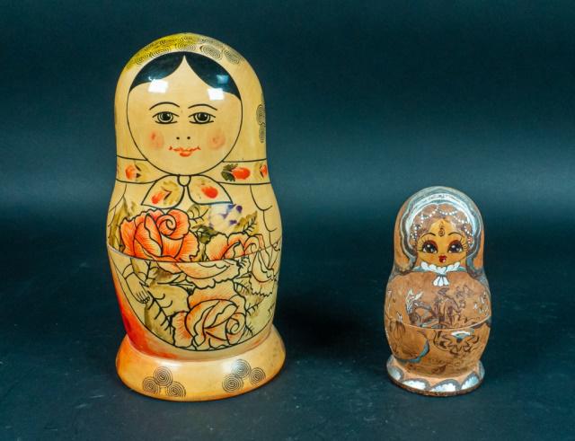 2 Matryoshka Russian Babushka Nesting Dolls: 2 wooden nesting dolls. One is labeled "Made in USSR", wooden dolls, set of 10, handpainted. One is dated "1993" and signed by the artist. Set of 5. Handpainted and wood burned.