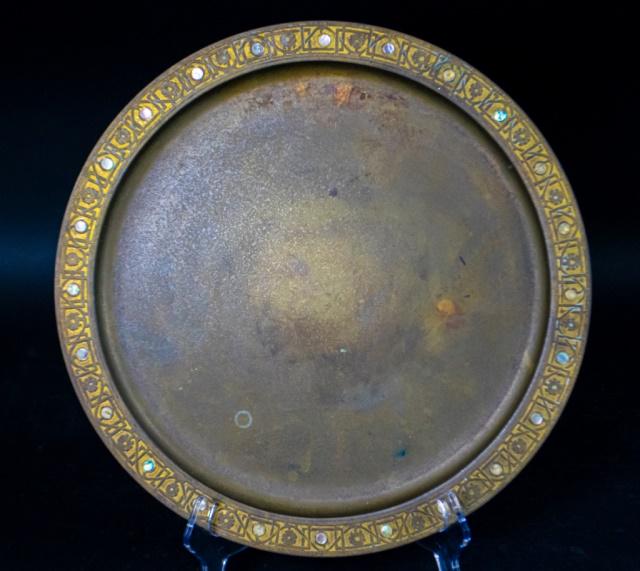 Tiffany Studios Bronze and Abalone Platter: Large bronze platter, ornamented outer rim inset with 24 mother-of-pearl discs. 8 of the 24 discs are missing. General Oxidation. 16 1/4"-diameter Stamped: "Tiffany Studios New York 1728"