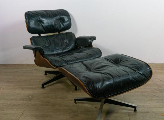 Eames For Herman Miller Lounge Chair and Ottoman: Charles(St Louis 1907-1978) and Ray (Sacramento 1912-1988) Eames for Herman Miller. Molded wood veneer shell with black leather upholstery, brushed aluminum mounts, swivel chair with stationary stool.