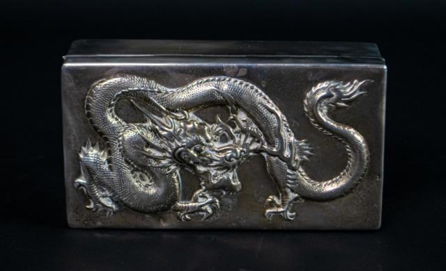 Wang Hing & Co. Chinese Export Silver Box: Chinese Export silver box, with repousse dragon motif on lid. Wang Hing & Co. WH90 mark and Chinese character mark to underside. Small dents to lid. 428.2 grams including wood lining. 6 1/2"L x 3 1/2"