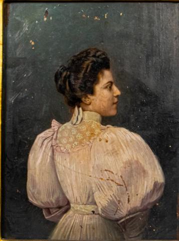 Oil on Board Portrait of a Lady Edwardian: Oil on board portrait of a lady in a pink dress with the left side of her face toward the viewer. The dress can be dated to the early 1900's. Loss on the top portion of the board, as well the bottom l