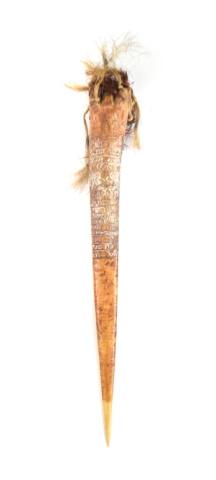 Cassowary Bone Dagger, Heavily Incised and Painted: Cassowary bone dagger, heavily incised and finely painted, with geometric design, fiber decoration, and mini-face carved into the inside top In his Diary, page 162 (lot 108 box F1), Ledoux explains: "