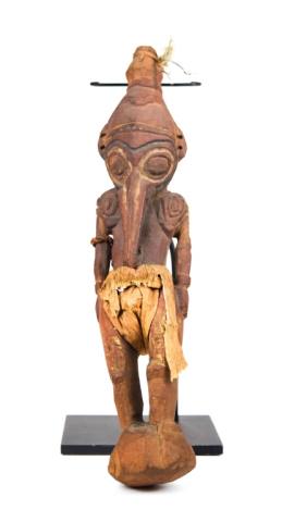 Lower Sepik River Figure, Male Kandimbong: Lower Sepik River Figure, male Kandimbong with loin cloth Lower Sepik River Figure, Kandimbong, with long nose, standing on pedestal, mask-like face, big round eyes, spiral design on shoulders and sho