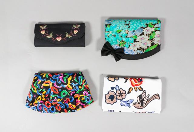 Collection of 4 Clutches: A collection of 4 clutches: A Leonardo fabric clutch. An Abro white leather clutch with traditional tattoo motifs. A Lulu Guinness fabric clutch. A Stuart Weitzman fabric clutch. Largest: 8 3/4" L x 5