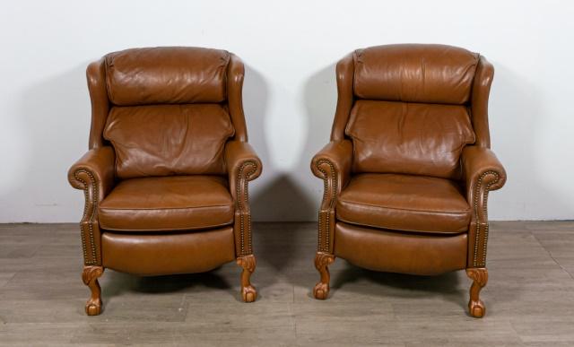 Pair of Presidential Leather Recliners: Pair of presidential leather recliners by Bradington Young. American, 20th Century. Ball & claw feet, wing back, leather upholstery and brass nail trim on arms and base. Some scuffs to feet and leathe