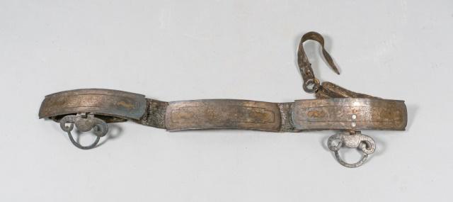 Tibetan Hide and Steel Belt: 18th to 19th Century Tibetan hide and steel belt. 5 metal panels decorated with intricate engravings. 2 engraved metal loops to sheath weapons. Leather perforated belt tip and decorated metal buckle a