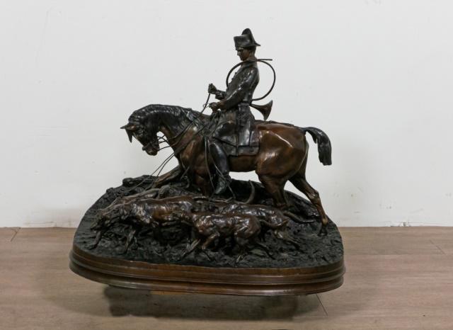 PJ Mene Fox Hunt Bronze Sculpture: After Pierre Jules Mene (French, 1810-1879). A hunter on horseback leading a pack of hounds. Signed on the edge: "PJ Mene 1869". 23 1/4" H x 14" W x 26 1/4" Diameter. Dirt accumulation in the reliefs.