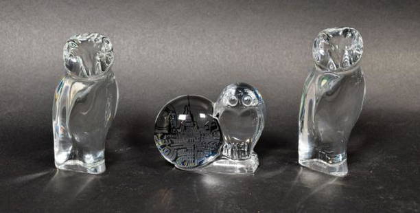 Grouping of Baccarat Crystal Owls: Grouping of Baccarat crystal owls. French, Mid 20th Century. Two standing owls, and a perched owl next to a cityscape. One standing owl is etched "BACCARAT" on base, other two figures have Baccarat