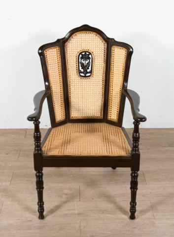 Caned Mahogany Armchair: Caned mahogany armchair. Early 20th Century, possibly a Chinese production. Mahogany chair, caned back and seat, carved flower motif on back caning. Scratches to right arm, some minor scuffing on legs