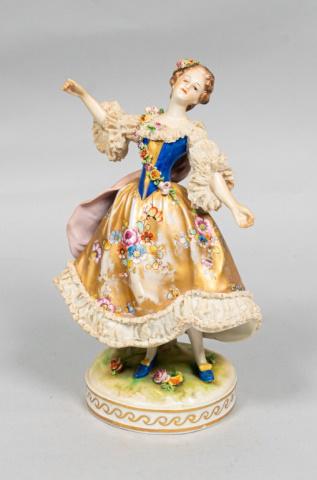 Rudolstadt Volkstedt Porcelain Figure: Early 20th century Rudolstadt Volkstedt porcelain figure with Dresden lace and flower garland. Repair on the underside. Lace chipped on the bottom and sleeves, missing paint to gold skirt. Blue Volkst