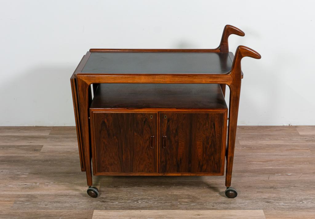 Arne Hovmand-Olsen Danish Modern Bar Cart: Arne Hovmand-Olsen (Danish, 1919-1989) Danish Modern bar cart. Mid 20th century. One dropside leaf. Both leaf and top have black water resistant panels. Lower cabinet for storage. Rolls on casters. Sc
