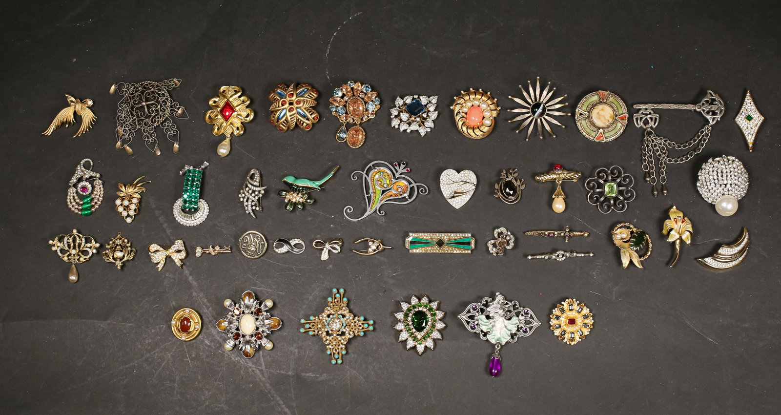 Grouping of Costume Jewelry Brooches: Collection of costume jewelry brooches featuring designers: Ciner, Cadoro, and Panetta as well designs from The Metropolitan Museum of Art shop.